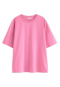 Lyserød bomulds t-shirt med rund hals og korte ærmer. Har en afslappet pasform med en glat, let tekstur og syet kant.