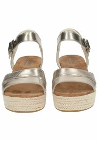 Metallic silver open-toe sandals with ankle straps, adjustable buckles, cushioned suede footbeds, and woven platform soles.