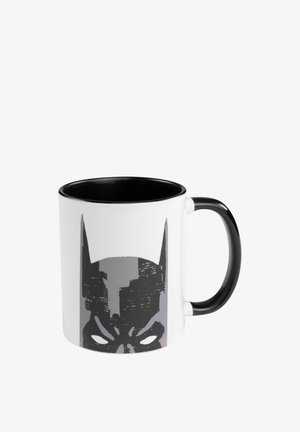 Ceramic mug with black interior and handle. Features a large gray Batman logo against a white background. Smooth texture, cylindrical shape.