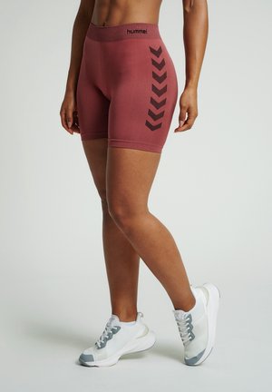 Burgundy athletic shorts with a high waistband, featuring black chevron patterns on the side. Paired with white and gray sneakers.