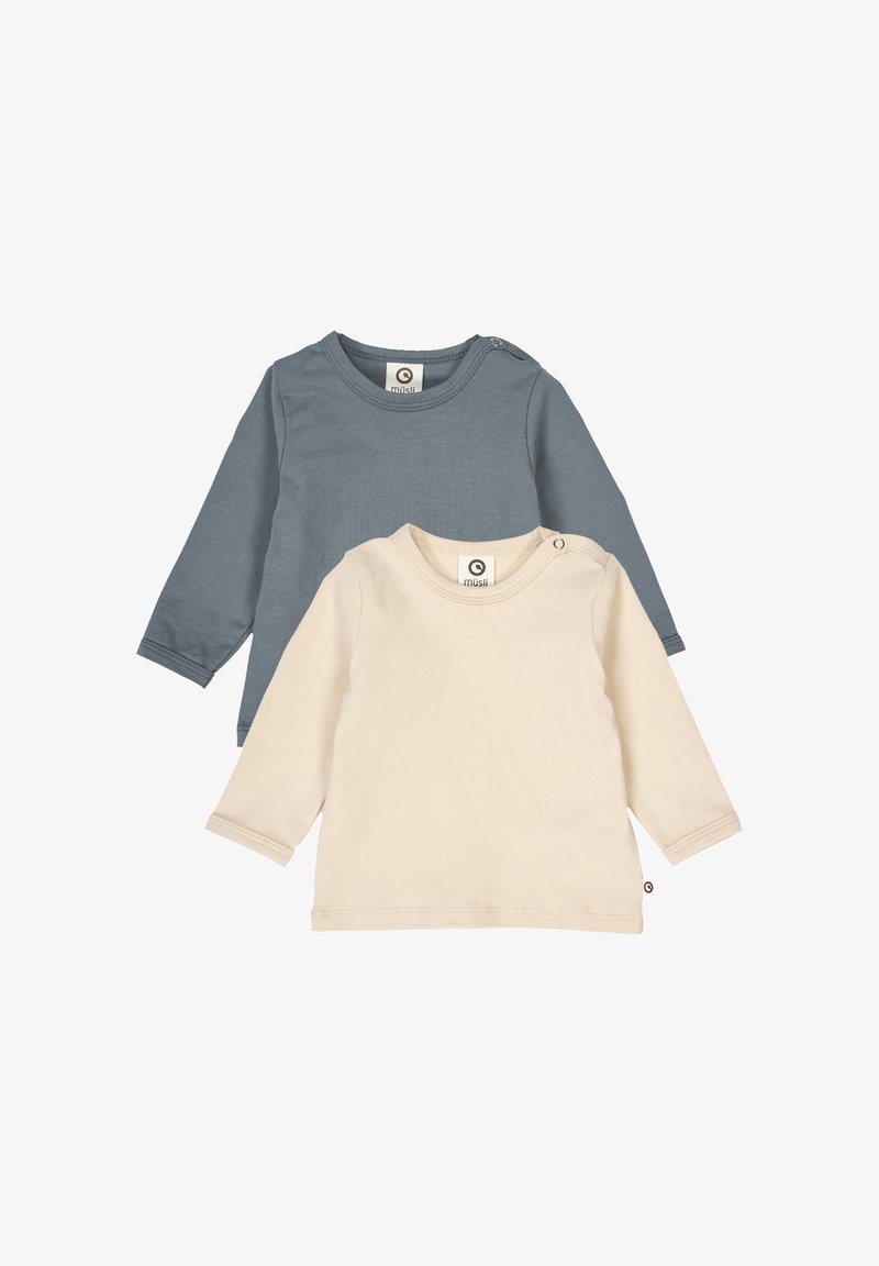 Two long-sleeve t-shirts: one in blue-gray, one in cream. Both feature round necklines, soft fabric, and small label accents.