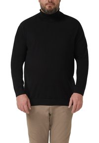 Schwarzer Rollkragenpullover mit langen Ärmeln, geripptem Kragen und Bündchen, aus einem glatten, dehnbaren Stoff, kombiniert mit hellbeigen Hosen.