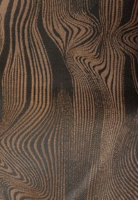 Textil con un patrón ondulado en tonos marrón oscuro y negro, con una superficie texturizada que crea profundidad y contraste.