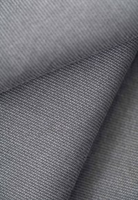 Textured gray fabric with a subtle pattern, showcasing a soft, woven appearance. The material features distinct woven threads and depth.