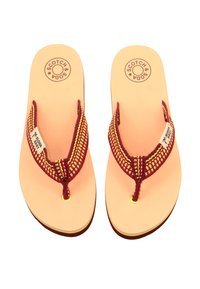 Brown flip-flops with a textured red and yellow woven strap, featuring a circular logo on a light pink footbed and black rubber sole.