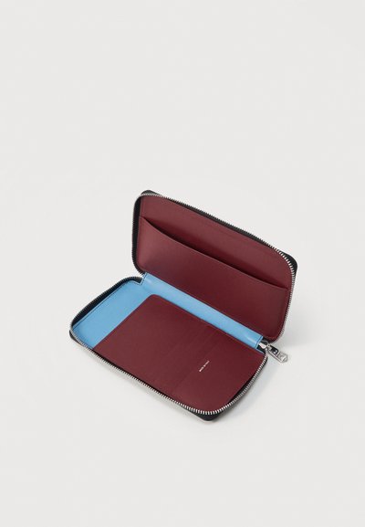 Ανοιχτό μαύρο πορτοφόλι με φερμουάρ που δείχνει εσωτερικό μπορντό με πολλαπλές θήκες καρτών και ανοιχτό μπλε φόδρα μέσα στο πορτοφόλι.