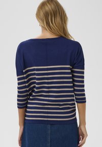 Blau-beiger gestreifter Pullover mit Dreiviertelärmeln, weicher Textur und lockerem Schnitt. Verfügt über einen runden Ausschnitt und gerippte Akzente.