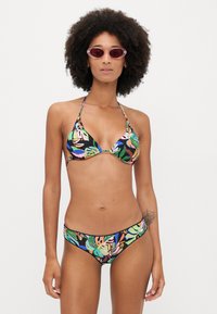 Bikini set featuring a colorful floral pattern on a black background. Material is stretchy, with a classic triangle top and comfortable bottoms.