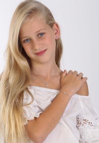 Silberschmuck umfasst eine Anhänger-Halskette, ein Armband und einen Ring mit floralen Akzenten. Das Model hat lange, glatte blonde Haare und blaue Augen.