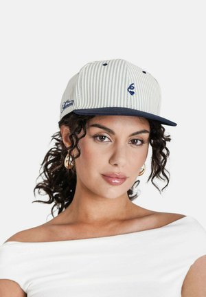 Gestreepte pet in lichtbeige en marineblauw, met een platte rand en geborduurd logo. Gemaakt van stof met een gladde textuur. Verstelbare band aan de achterkant.