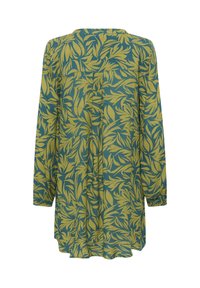 Tunique à manches longues en imprimé floral vert et jaune. Tissu léger avec une coupe décontractée, un ourlet incurvé et des détails de plis à l'arrière.