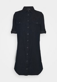 Ciemnoniebieska koszula dżinsowa z guzikami z przodu, krótkimi rękawami z mankietami, dwoma kieszeniami na piersiach oraz zaokrąglonym dołem. Posiada srebrne detale.