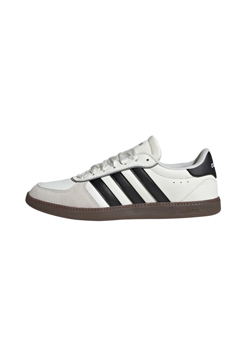 White athletic shoe with black three stripes design, made of leather and suede. Features a rubber sole and lace-up front.