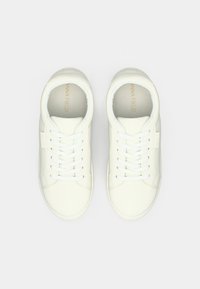 Ein Paar weiße Schnürsneaker mit sichtbarem "ANNA FIELD"-Branding innen und auf den seitlichen Etiketten, von oben auf einem weißen Hintergrund betrachtet.