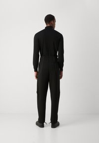 HUGO NIPIPEPANT - Tracksuit bottoms - black