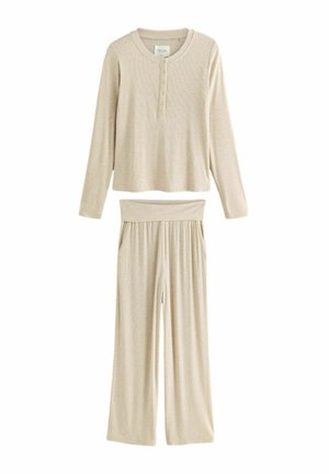 Beige ribbad långärmad topp med knapplist och vida byxor med elastisk midja. Mjuk textur genom hela plagget.