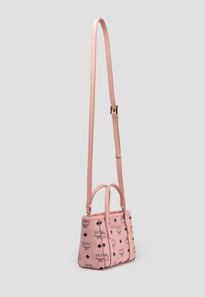 Pink leather handbag with contrasting black logo print, dual top handles, and a long adjustable strap. Rectangular shape with structured design.