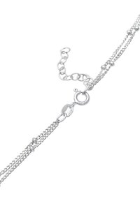 Silver chain bracelet featuring multiple strands, with a lobster clasp and circular links. Includes small round accents for decoration.