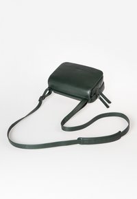 Borsa a tracolla in pelle verde scuro, con forma rettangolare, chiusura con zip e tracolla regolabile. Texture liscia con un sottile dettaglio di branding.