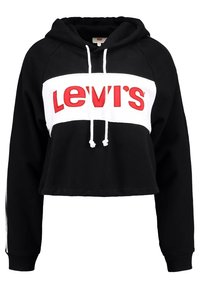 Felpa nera cropped con striscia bianca e il logo rosso "Levi's". Corda nel collo e polsini a costine. Tessuto morbido.