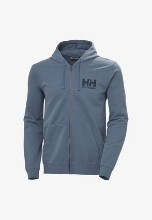 Sudadera azul con cremallera, hecha de un tejido suave, que cuenta con un bolsillo tipo canguro, puños acanalados y un logo de Helly Hansen en el pecho. Textura suave.