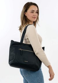 Black leather tote bag with a textured finish, featuring a front zipper pocket, gold hardware accents, and two sturdy shoulder straps.