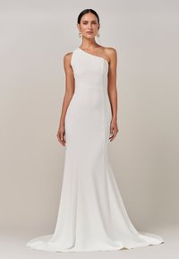 Valkoinen, yhdelle olalle menevä mekko, jossa on tiukka yläosa ja levenevä helma. Sujuva, sileä kangas luo virtaviivaisen siluetin. Elegantti muotoilu.
