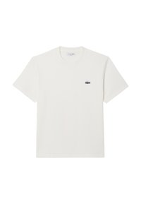 T-shirt bianco in cotone con maniche corte e scollatura a girocollo. Presenta un piccolo logo ricamato di Lacoste sul lato sinistro del petto.