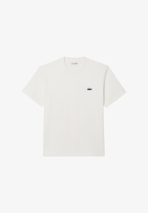 White cotton t-shirt with short sleeves and a crew neckline. Features a small, embroidered Lacoste logo on the left chest.