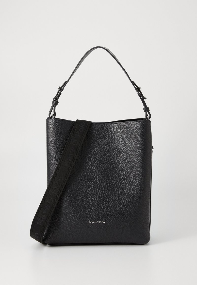 Black leather handbag with a pebbled texture. Features a flat base, top handle, and a detachable strap with logo. Minimalistic design.