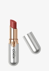 Rouge à lèvres dans un étui argent métallisé, avec une touche de rose doré et une teinte mauve crémeuse. Le capuchon est partiellement retiré, révélant le bâtonnet.