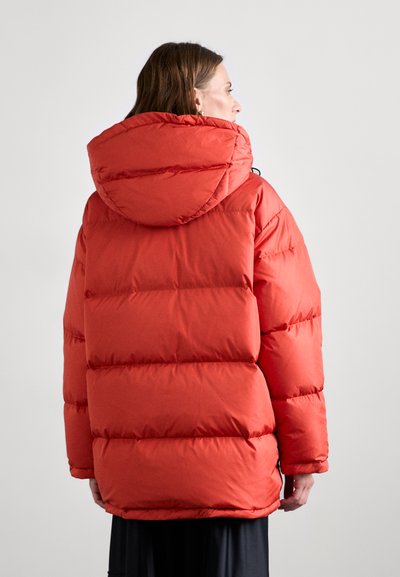 Rode pufferjack met een ruime capuchon, gestikt ontwerp en een zachte textuur. Heeft een losse pasvorm en elastische manchetten voor comfort.