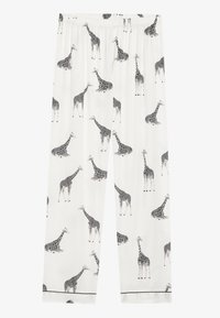 Białe spodnie piżamowe z czarnym wzorem w żyrafy, z elastycznym pasem i kontrastowym czarnym wykończeniem na dole.