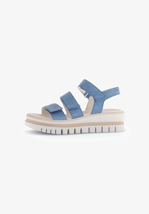 Blue denim sandals with three adjustable straps, a white chunky sole, and subtle horizontal grooves for grip.