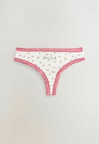 Brazilian tanga albă cu un model floral roz, talie din dantelă și cu "Wednesday" brodat în verde. Material din bumbac moale, textură delicată.