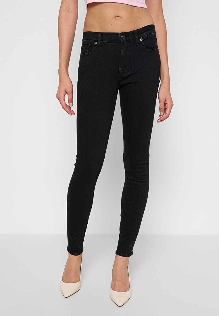 Schwarze Skinny Jeans aus dehnbarem Denim, mit zwei vorderen Taschen, einem Knopfverschluss und einem eleganten Design, das sich an den Knöcheln verjüngt.