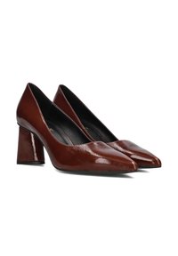 Brown patent leather high heels with a pointed toe and block heel. Smooth texture and glossy finish, featuring a simple, classic design.