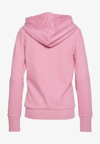 Pink hoodie with a spacious hood, ribbed cuffs, and hem. Soft fabric with a smooth texture. Back view shows a clean, simple design.