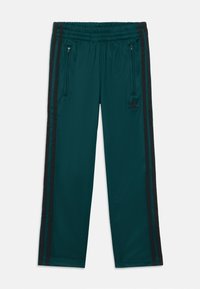Teal träningsbyxor med elastisk midja, med svarta sidostråkar och fickor med dragkedja. Materialet har en slät, glänsande yta.