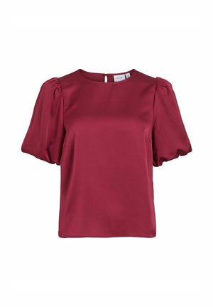 Blouse bordeaux à manches courtes en tissu lisse, avec un col rond, des manches bouffantes et un détail discret en forme de trou de serrure dans le dos.