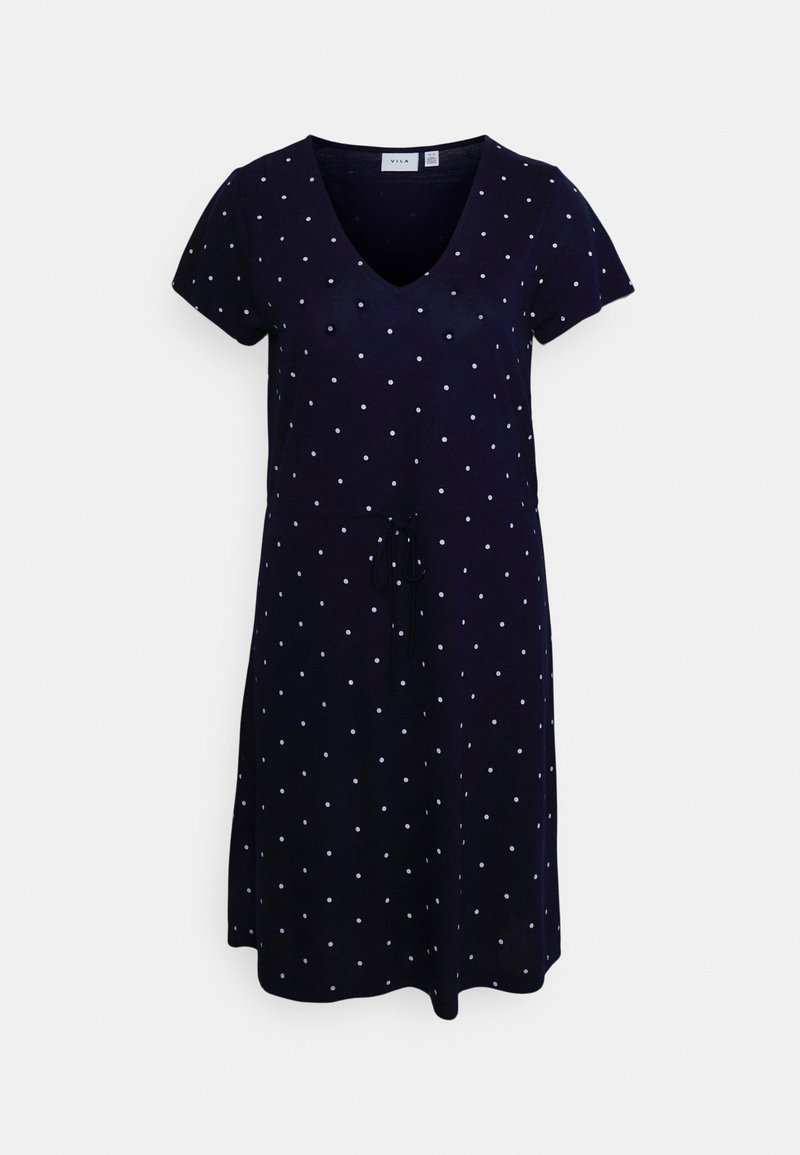 Námořnická modrá šaty s krátkými rukávy a výstřihem do V. Mají bílá puntíky a zavazování v pase, vyrobené z měkké, lehké látky.