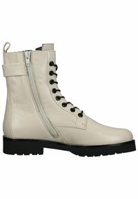 Botas de piel beige con cordones, cremallera lateral, ojales negros y suela de goma plana. Parte superior texturizada con un diseño minimalista.
