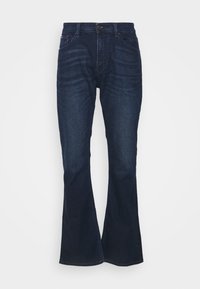 Pantalones vaqueros acampanados de color azul oscuro en material de denim con un diseño clásico de cinco bolsillos, cierre de botón y un ligero desgaste a lo largo de las piernas.