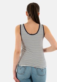 Camiseta de tirantes a rayas en colores marino y blanco, con cuello redondo y diseño sin mangas. Tejido ligero con una textura suave.