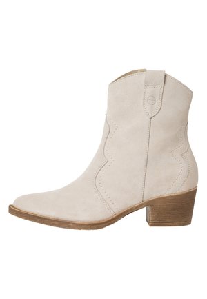 Beige suede ankle boot with a low wooden block heel, pointed toe, and decorative stitching along the side and heel pull tab.