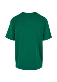Grøn bomulds t-shirt, korte ærmer, klassisk rund hals, glat tekstur, lige søm, set bagfra. Ingen synlige logoer eller mønstre.