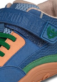Blue and orange sneaker with green laces, suede and mesh materials, Velcro strap, rubber sole, and a green logo accent detail.