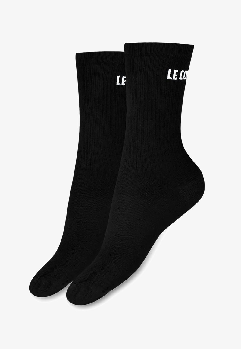 Calcetines de algodón negros de corte crew con textura acanalada, que presentan el texto blanco "LE CO" en la parte superior. Acabado suave y forma estándar de calcetín.