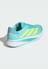 Turquoise athletic shoes with mesh upper, neon yellow accents, and white sole. Features textured design and reinforced heel for support.