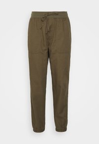Olivengrüne, leichte Baumwollhosen mit einem elastischen Bund und Kordelzug. Mit elastischen Bündchen und zwei Fronttaschen.